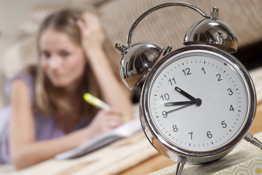 Young blonde woman is studying at home
